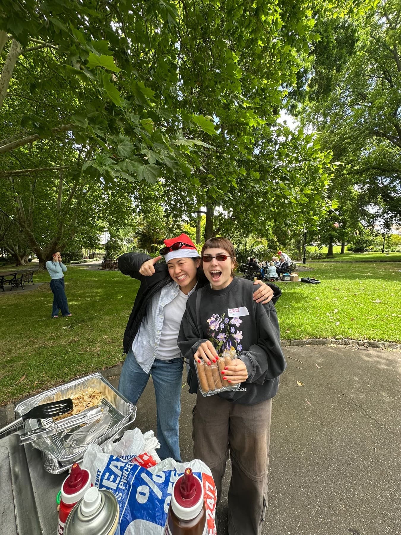 Two guests smiling together at an outdoor Inspector Byte gathering